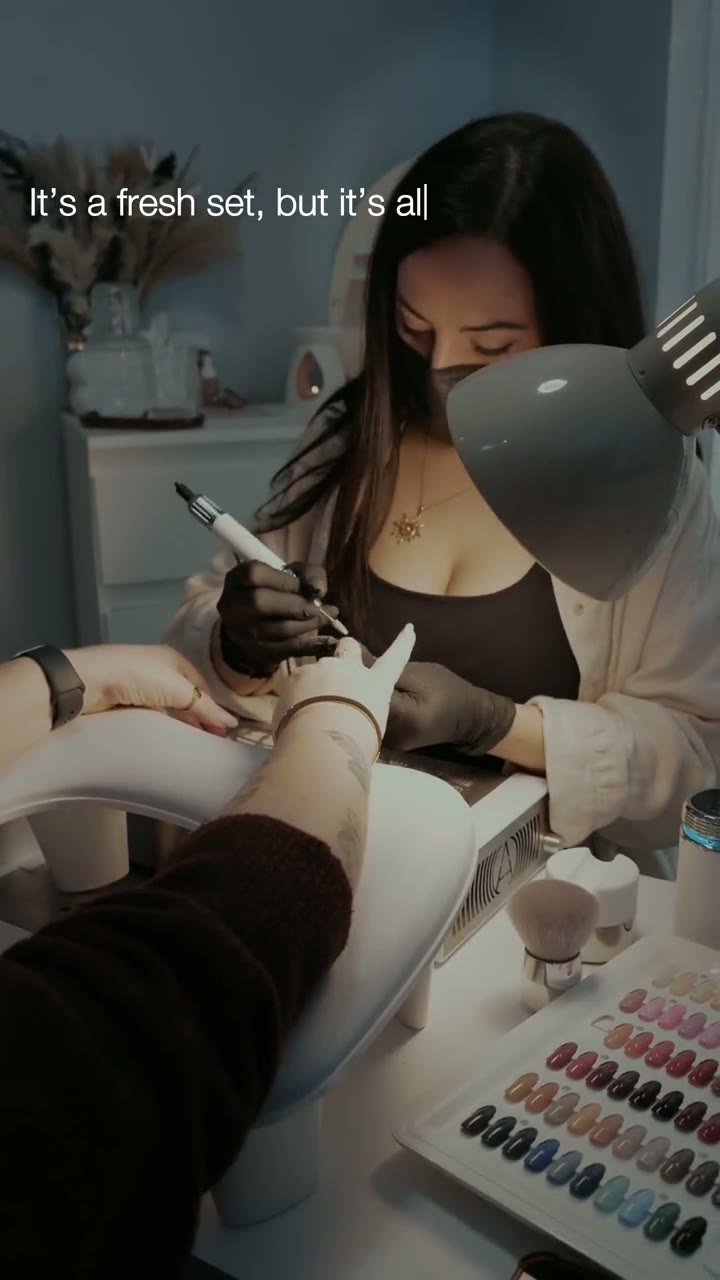 A nail artist working on a fresh manicure